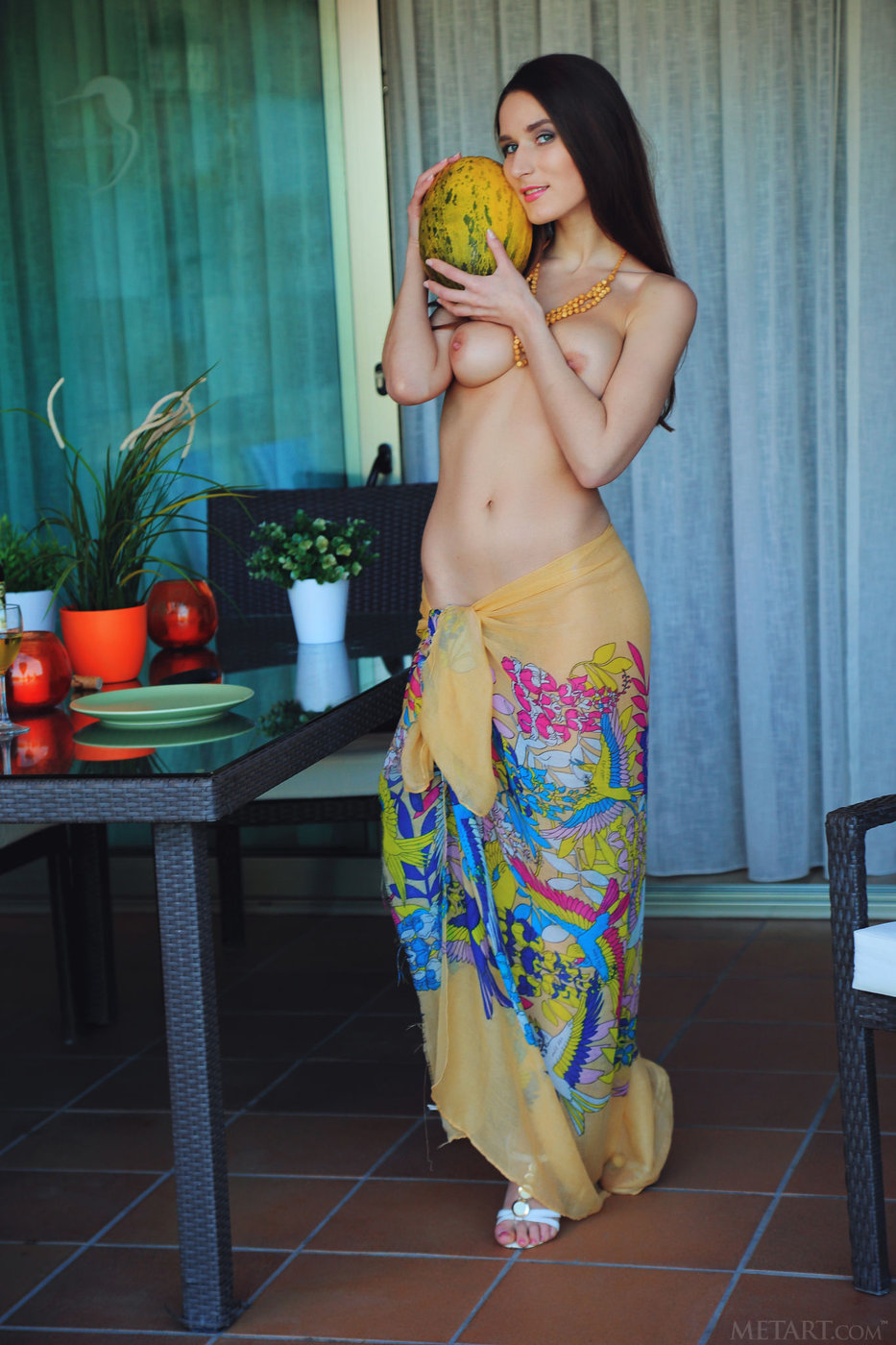 Zuria: Topless sarong-wearing beauty suggestively fingering the fruit.