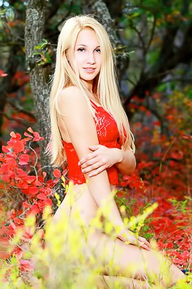 Blonde in red gets naked in the middle of a field of red flowers Videos