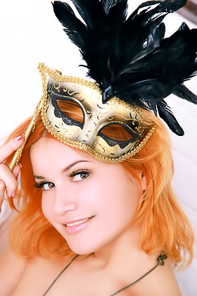 Redhead takes off her carnival mask along with the rest of her outfit Videos